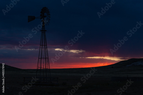 A Windmill Silhouette on the Prairie at Sunset