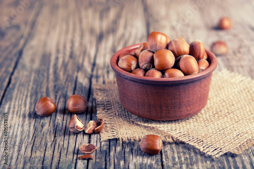 Hazelnuts in a bowl on a wooden table. Delicacies. healthy and beneficial food, vintage wooden background, selective focus