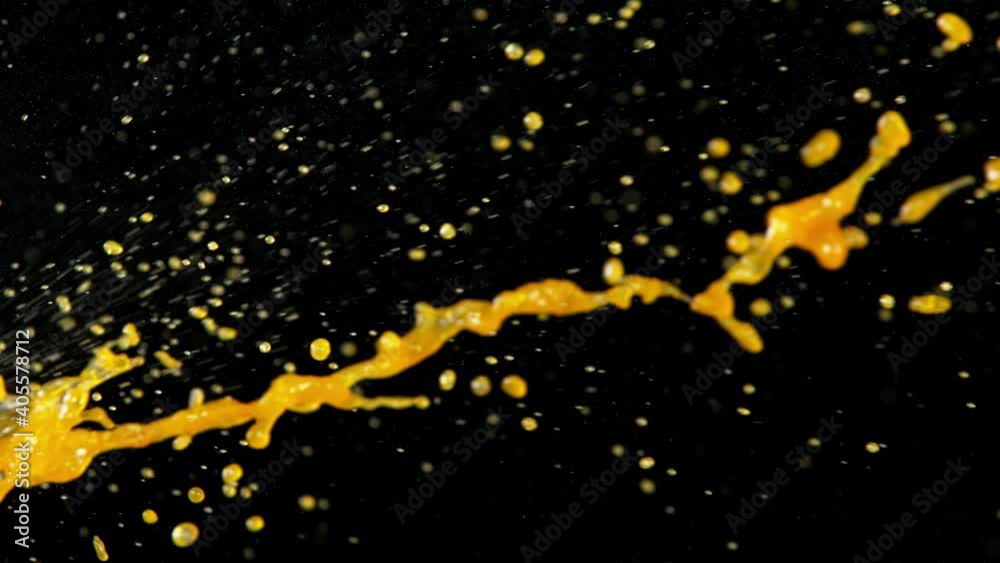 Super slow motion of orange splashes on black background. Filmed on high speed cinema camera, 1000 fps Super slow motion of orange splashes on black background. Filmed on high speed cinema camera, 1000 fps