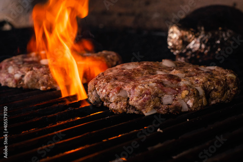 steel grilled meat burger with wood flame fries in metallic foil herbs oregano cordoba argentina