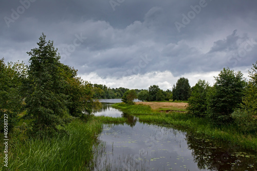 natural summer landscape with river and trees in stormy weather