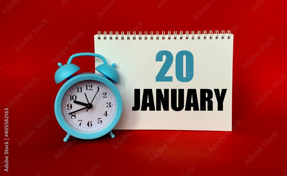 January 20 on a white Notepad .Next to it is a blue clock on a red background.Calendar for January . January 20 on a white Notepad .Next to it is a blue clock on a red background.Calendar for January .