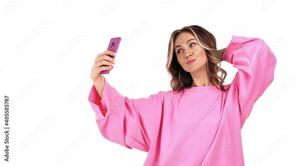 Adorable female in pink jumper posing taking selfie on mobile phone. 4k Dragon RED camera Adorable female in pink jumper posing taking selfie on mobile phone. 4k Dragon RED camera