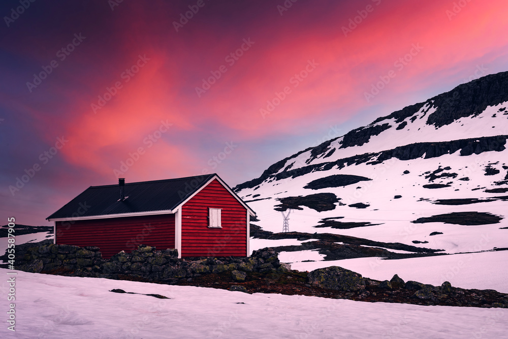 Typical norwegian red wooden house near famous Aurlandsvegen (Bjorgavegen) mountain road in Aurland, Norway in sunset time. Landscape photography