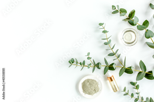 Eucalyptus essential oil, eucalyptus leaves on white background. Natural, Organic cosmetics products. Medicinal plant. Natural Serums. Flat lay, top view.