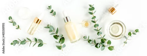 Obraz Eucalyptus essential oil, eucalyptus leaves on white background. Natural, Organic cosmetics products. Medicinal plant. Natural Serums. Flat lay, top view.