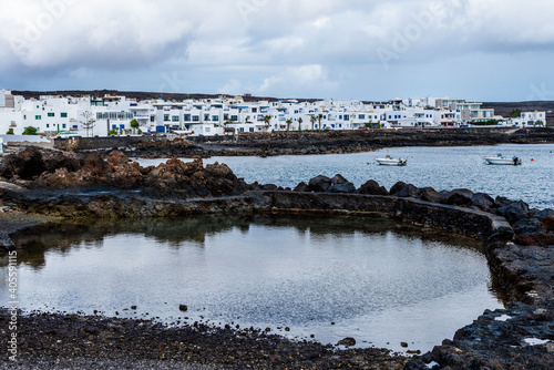 Natural pools of Punta Mujeres with the traditional white houses of the town in the background