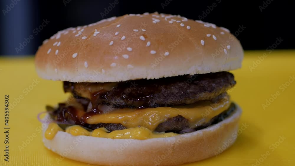 Delicious burger on the yellow table. Delicious burger on the yellow table.