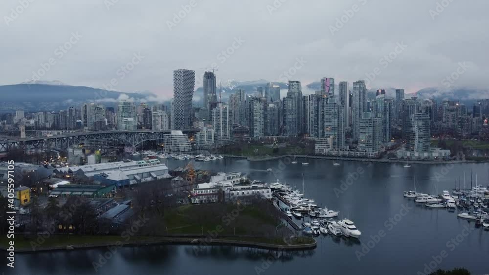 Aerial view of Vancouver downtown with mountains and low clouds on background Aerial view of Vancouver downtown with mountains and low clouds on background