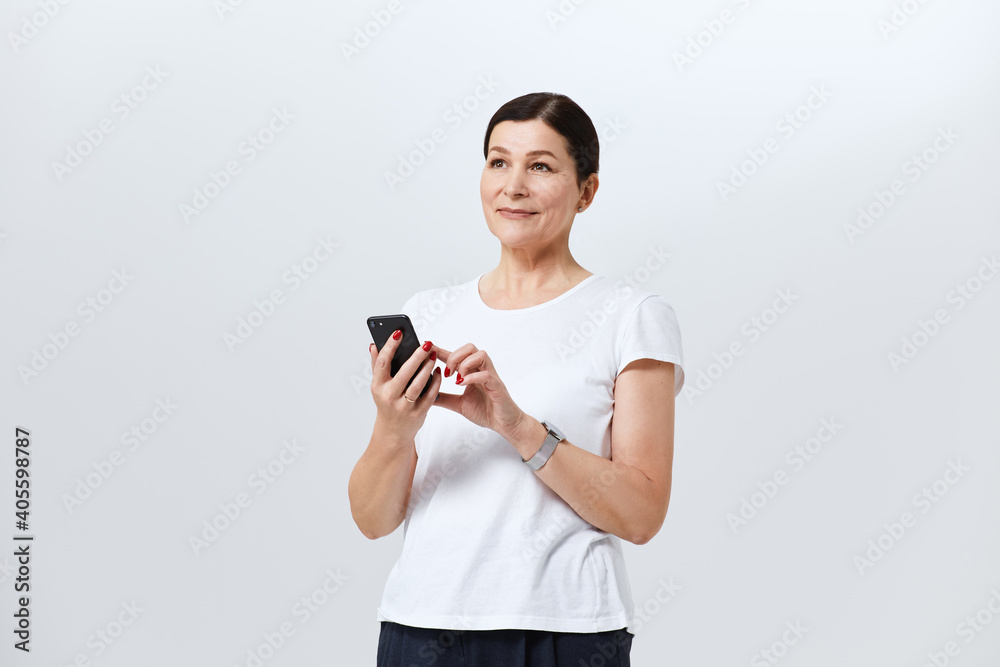 Portrait of a woman holding mobile phone, studio Portrait of a woman holding mobile phone, studio