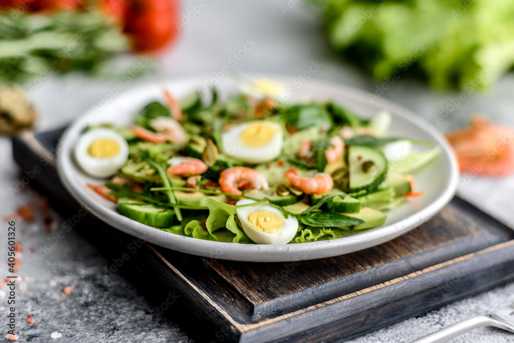 Salad with shrimp, avocado, cucumber, pumpkin seeds and flax seeds with olive oil