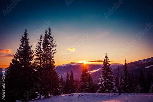 Beautiful dawn in the winter snow-covered mountains and amazingly beautiful clouds