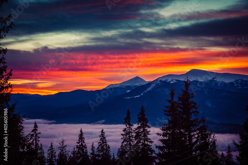 Beautiful dawn in the winter snow-covered mountains and amazingly beautiful clouds