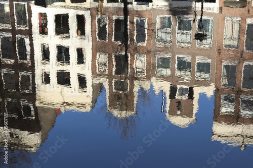 Amsterdam Canal Houses Reflection with Blue Sky and Winter Tree photo