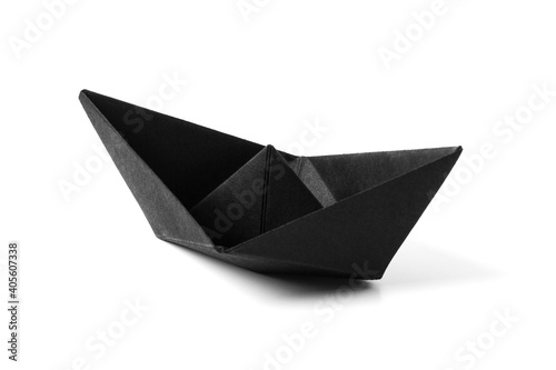 Origami black paper boat isolated on white background. Close up. Copy space.