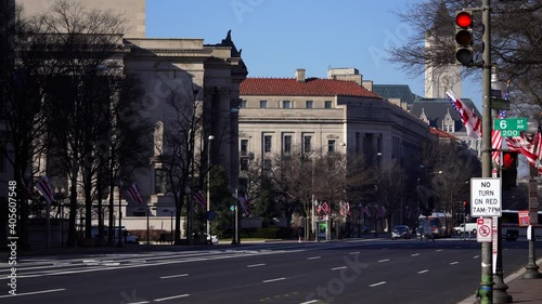 Washington, DC, USA - December, 12, 2020: Almost empty Pennsylvania avenue and waving flags of USA and District of Columbia