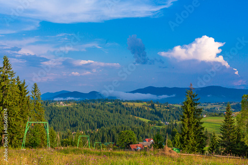 Summer view of hill with elevator for ski tourists. Mountains landscape background