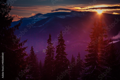 Beautiful dawn in the winter snow-covered mountains and amazingly beautiful clouds © Denis