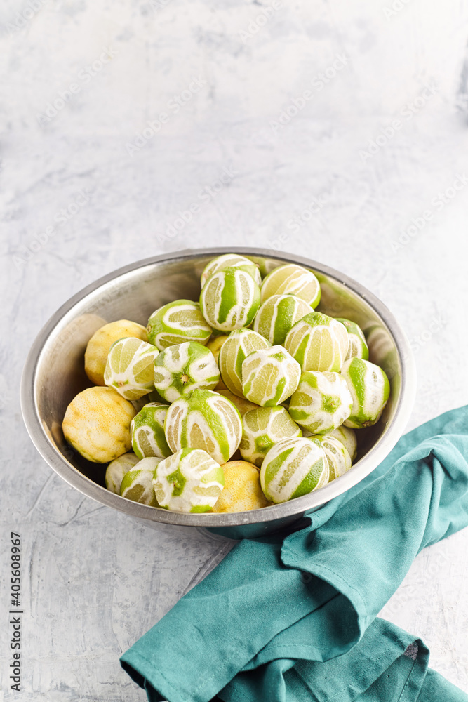 Bowl with fresh ripe limes on bowl and clear background Bowl with fresh ripe limes on bowl and clear background