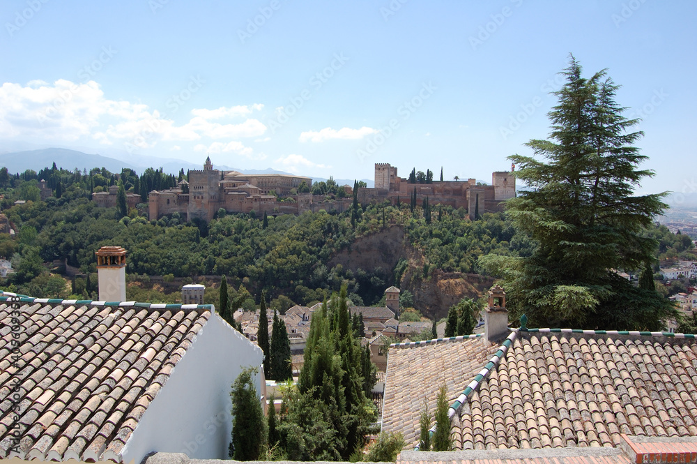 View of the streets and old buildings of Granada, historic city of Andalusia (Spain). The Alhambra from the viewerpoint of San Nicolas
