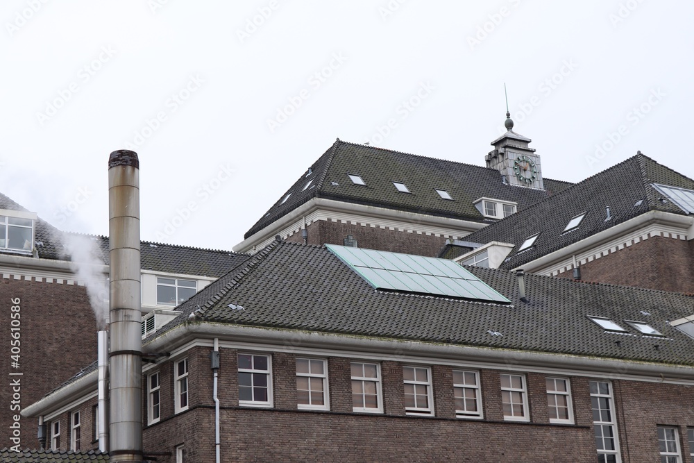 Former Hospital Building with Flue and Solar Panels on the Roof in Amsterdam
