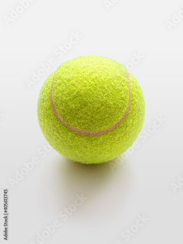 Yellow tennis ball on a light background © roundex