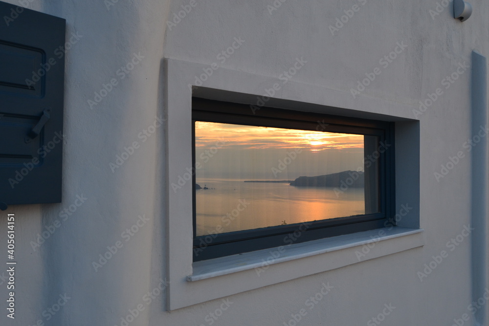 Amazing sunset view reflected by window in Oia, Santorini island in Greece Amazing sunset view reflected by window in Oia, Santorini island in Greece
