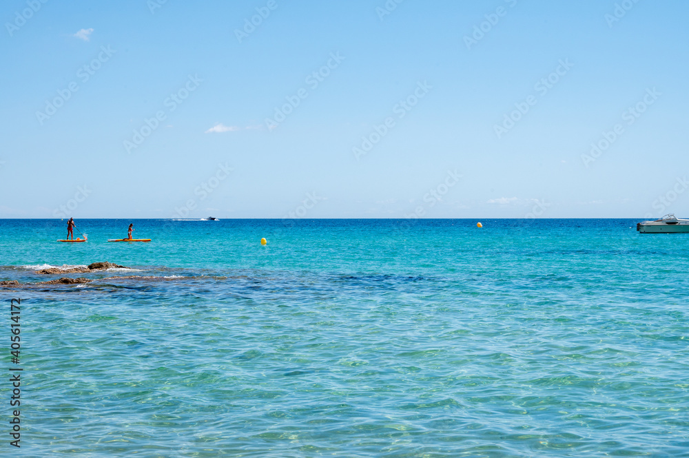 Fototapeta premium Summer vacation on French Riviera, crystal clear azure blue water of Mediterranean sea in Saint Clair near Le Lavandou, Var, Provence, France