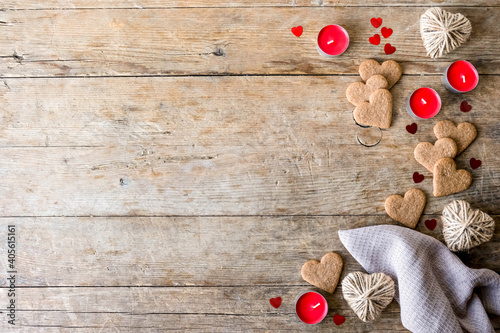 festive flat lay on a valenrtine's day has cookies hearts, confetti, candles, jute heatrs. zero waste and do it yourself concept photo