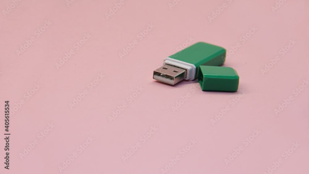 green USB flash drive with open lid on a light background green USB flash drive with open lid on a light background