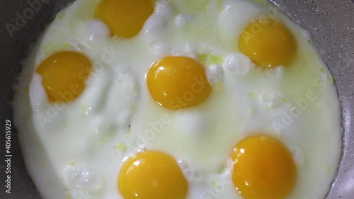 Roasting eggs in a frying pan. Scrambled eggs are fried in a frying pan, there is steam. Full HD video quality