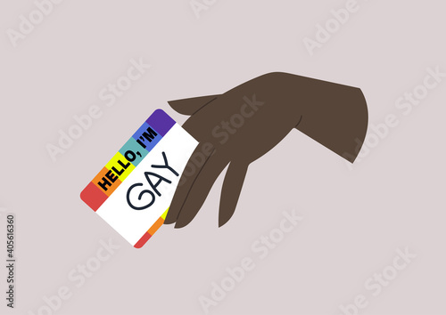 Coming out, a hand holding a rainbow name tag with the word gay on it, LGBTQ community