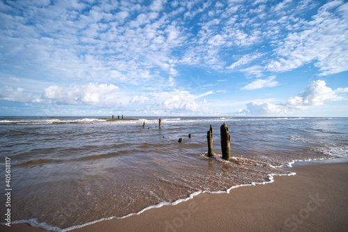 Fototapeta Naklejka Na Ścianę i Meble -  the baltic sea beach is so romantically beautiful and calm, small waves and sun shining in the clouds