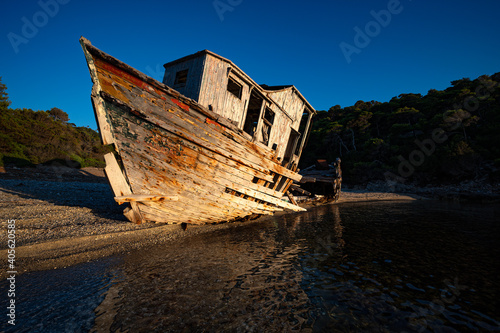 Shipwreck abandoned at a sea-coast of Skyros island in Greece in sunset