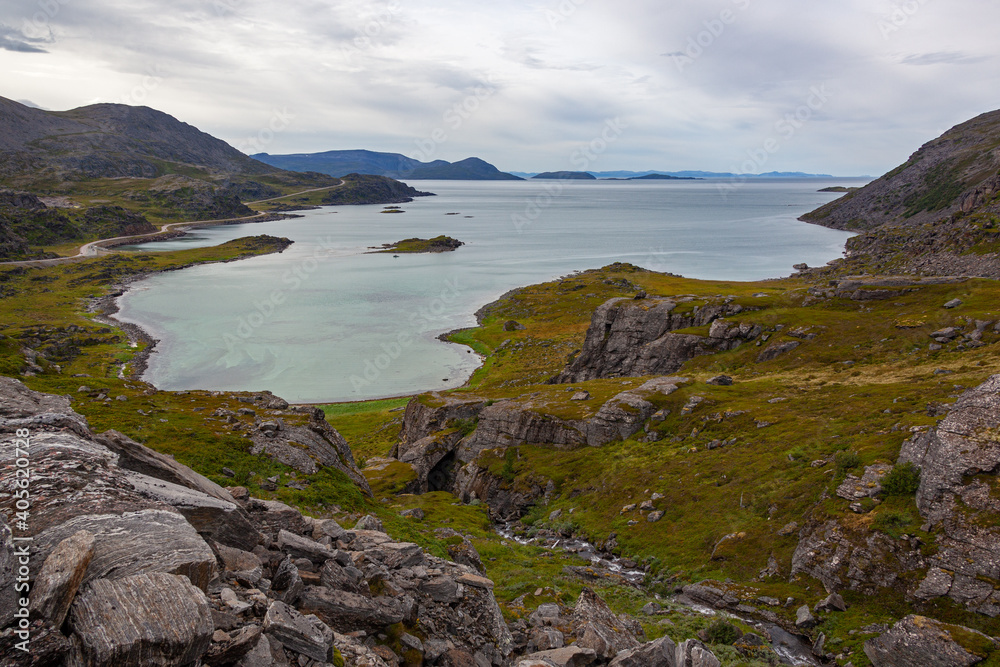 Fototapeta premium Impressive aerial view of the Barents sea and rocky shore in cloudy weather, in the neighborhood of the Olderfjord, Norway.