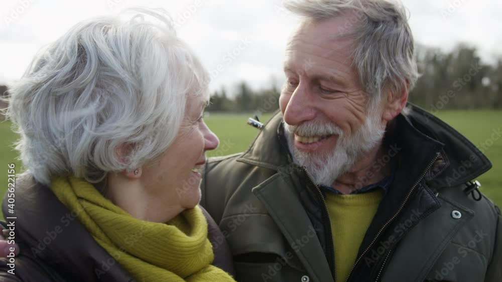 Portrait Of Loving Senior Couple Enjoying Autumn Or Winter Walk Through Park Together Portrait Of Loving Senior Couple Enjoying Autumn Or Winter Walk Through Park Together