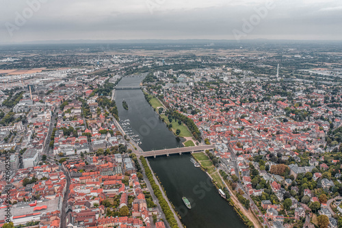 Aerial drone shot of Neckar river through Heidelberg new town in overcast summer morning
