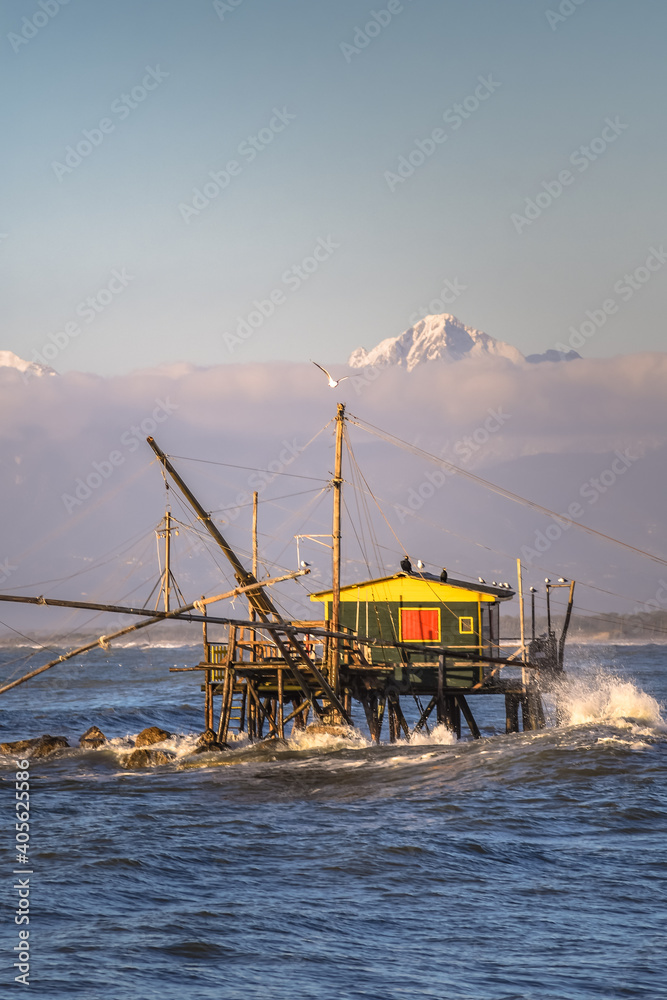 A fishing platform and mountains full of snow