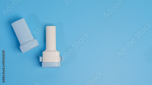 COPD or Asthma medication instruments a capsule Inhaler .On blue background.