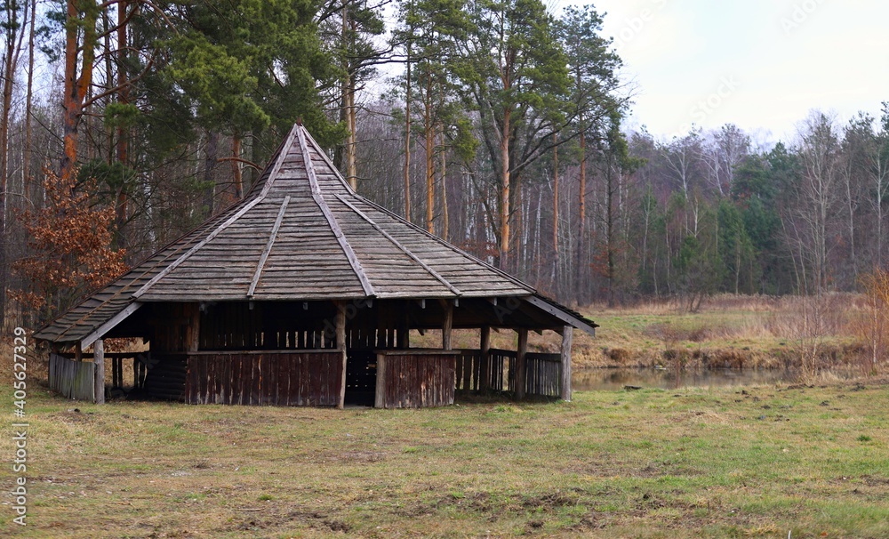 old wooden gazebo in the woods by the pond old wooden gazebo in the woods by the pond