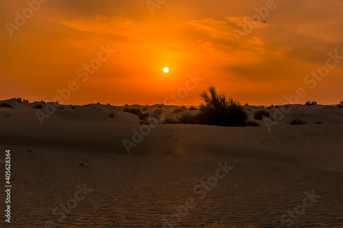 The sun setting in the desert outside Dubai, UAE in springtime