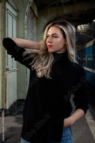 Portrait of a young beautiful woman in a leather jacket at the train station peron. Waiting for the train Vitebsk station St. Petersburg. © Алексей Васильев