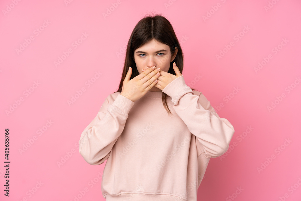 Young Ukrainian teenager girl over isolated pink background covering mouth with hands Young Ukrainian teenager girl over isolated pink background covering mouth with hands