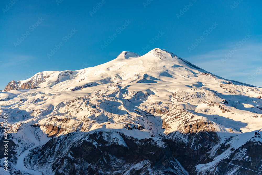 Mount Elbrus in winter. View of Elbrus from the nearby Cheget Mountain. Hats of Elbrus in the winter of 2021