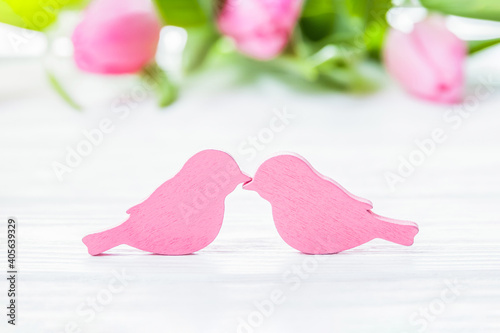 Romantic couple of birds kissing and pink tulips, love card