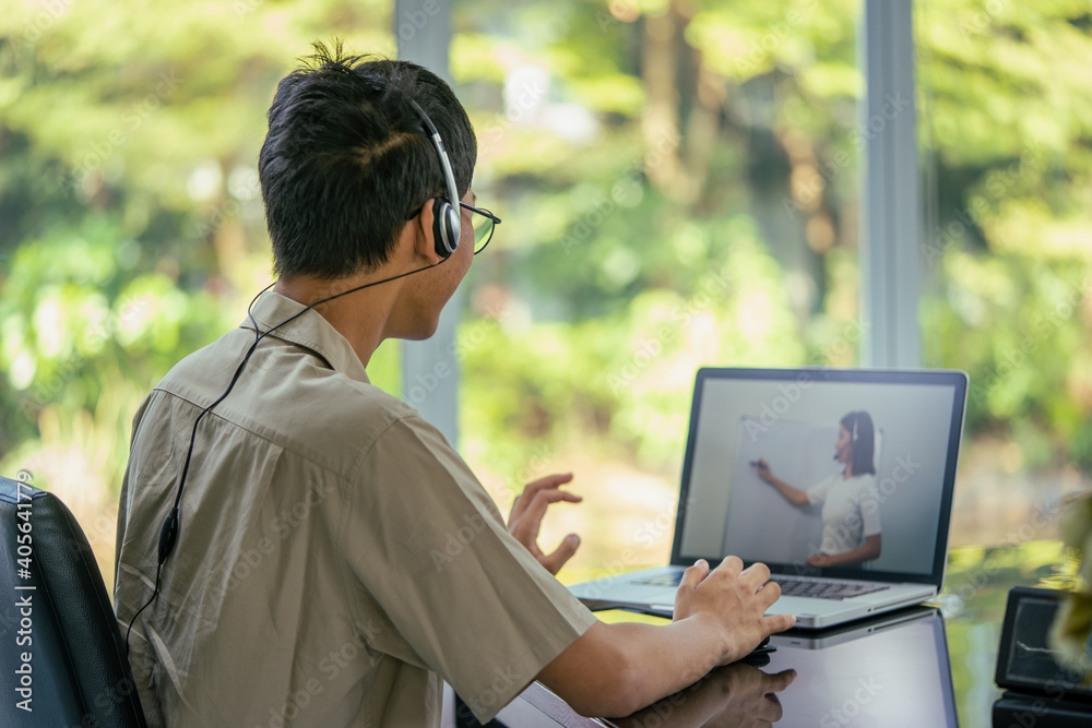 Education learning online concept, Asian Teenage student wear headphone using computer studying online. New normal style. Education learning online concept, Asian Teenage student wear headphone using computer studying online. New normal style.