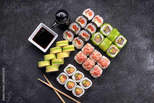 Sushi set of different rolls  with flying fish caviar  tobiko  shrimp  eel  salmon  avocado  sticks and soy sauce