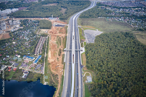Bilde på lerret Aerial view of expressway in rural area and subway metro station in the middle