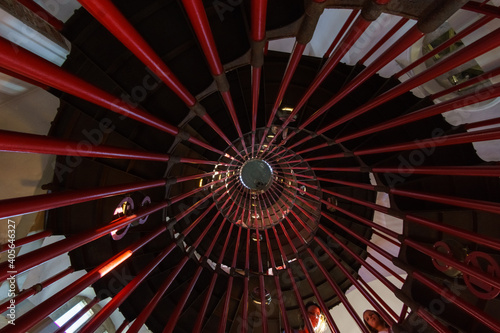 inside spiral steel staircase with red pipes in tower