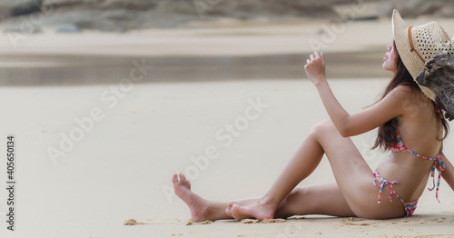 Happy lifestyle asian woman in sea beach, relax on the beach in summer. Travel Concept